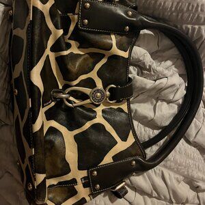dooney & bourke giraffe print leather shoulder bag with a logo lock clasp.